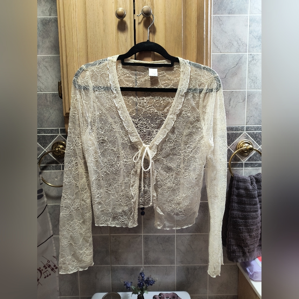 Sheer floral patterned lacey cream colored tie front cardigan